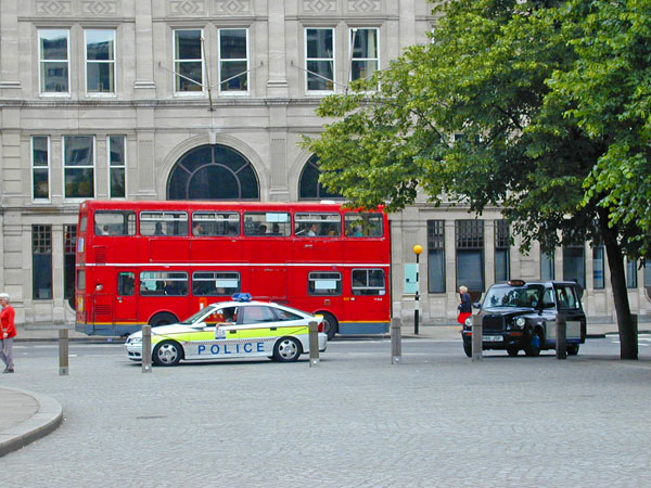 British bus, police car and taxi